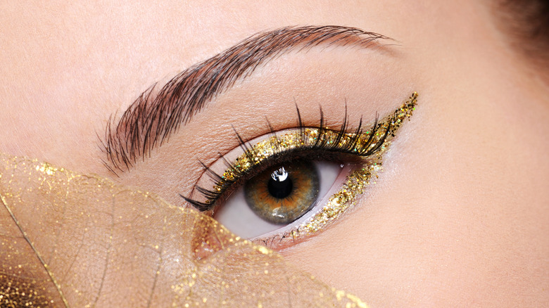 Hazel eye with sparkly gold eyeliner