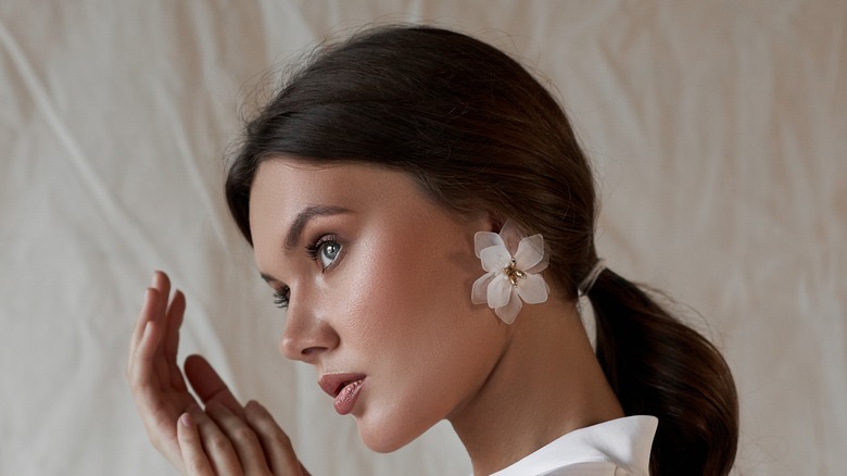 Girl wearing flower earrings.