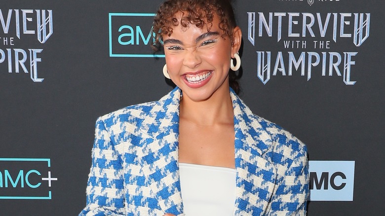 Smiling girl wearing chunky acrylic hoops.