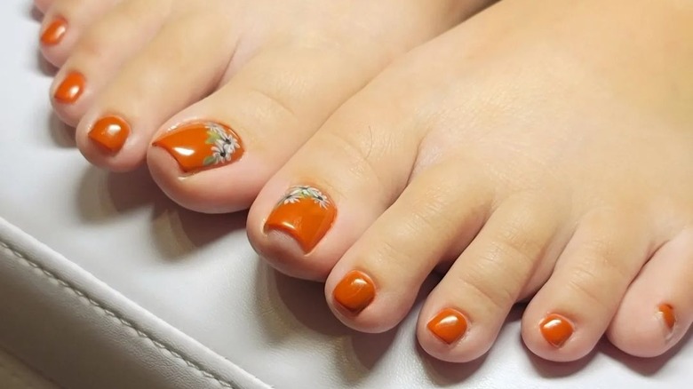 Woman with harvest orange nails 