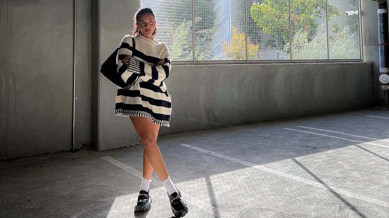 Influencer wears striped sweater dress