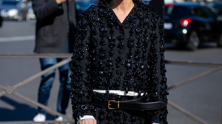 woman wearing black embellished jumper