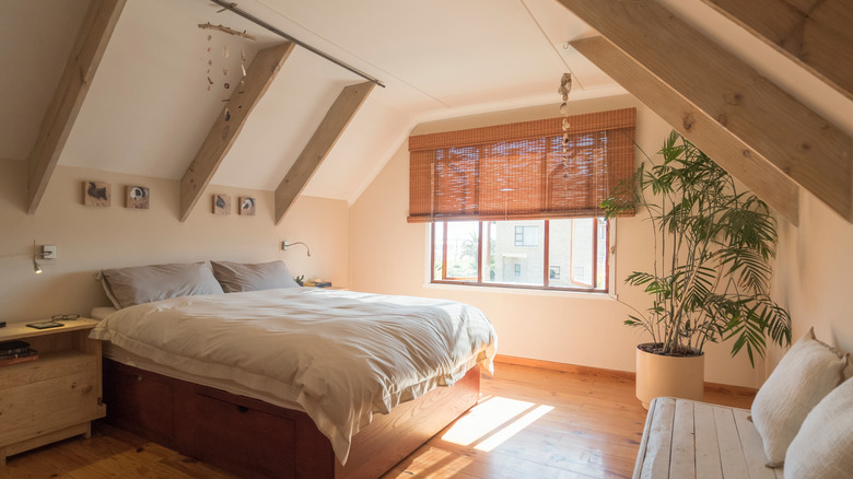 Sloped wall with beams over bed