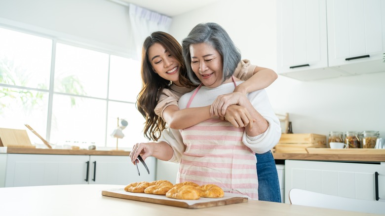 daughter hugging mom from the back