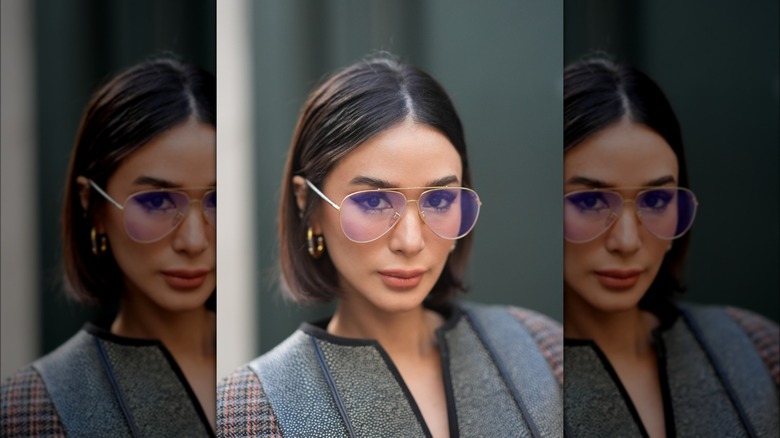 Woman with flippy bob tucked behind ears