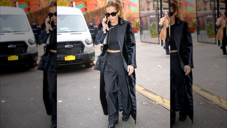 Woman wearing floor-length black velvet coat