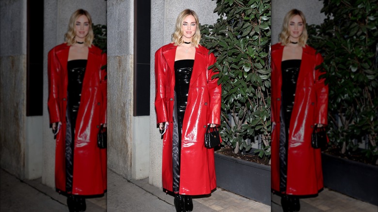 Woman wearing red pvc trench coat