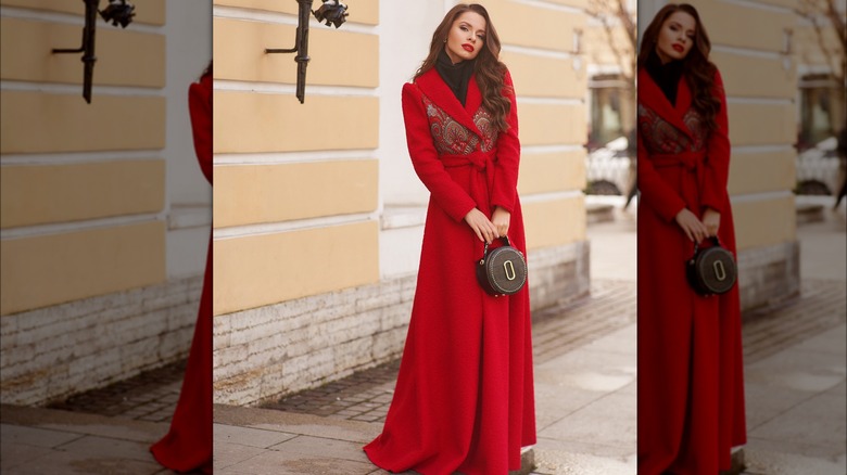 Woman wearing floor-length wrap around red coat