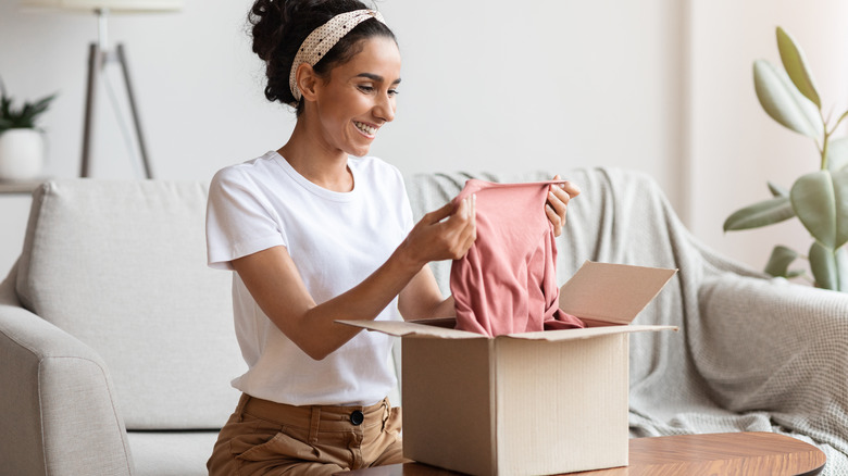 woman opening box with clothes