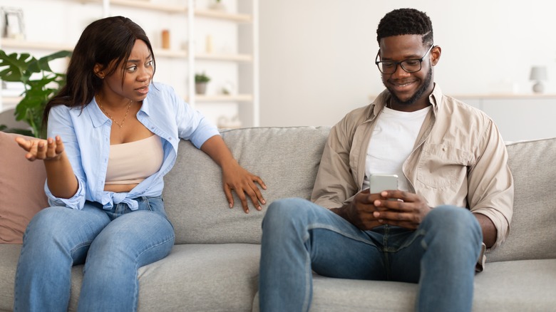 woman talking to distracted man