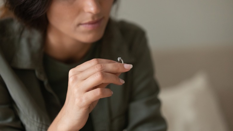 unhappy woman looking at ring