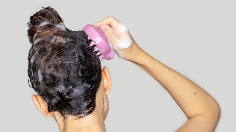Woman using scalp massager