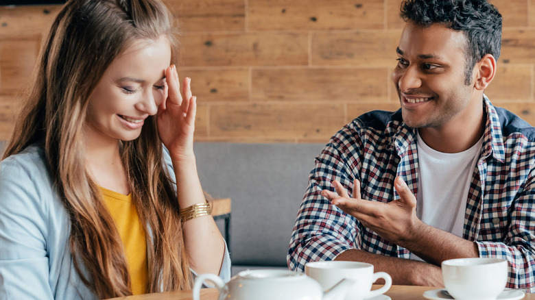 Smiling man with shy woman