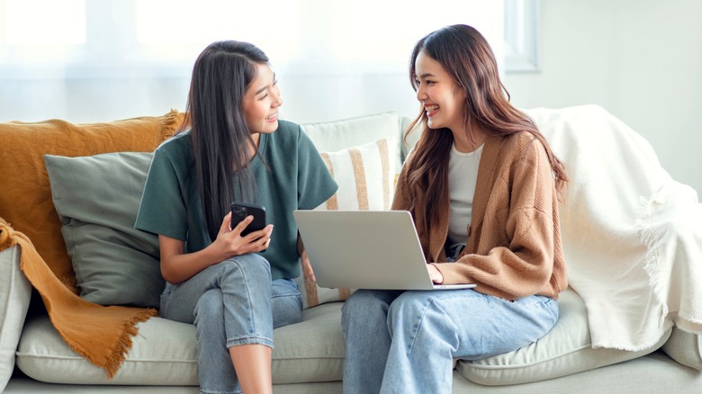 Two friends on couch smiling