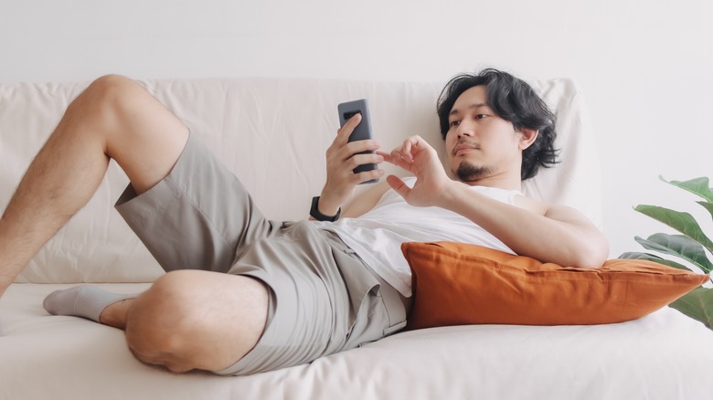 Asian man checking phone