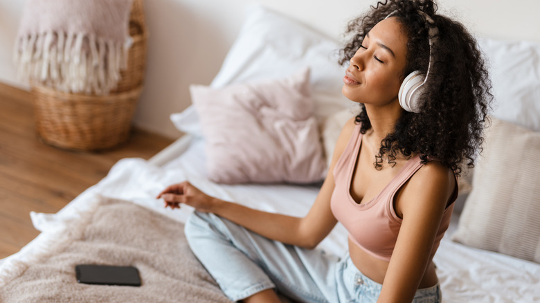 Black woman meditating with headphones