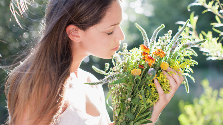 woman smelling bouquet