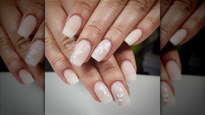 hands with floral french fade nails