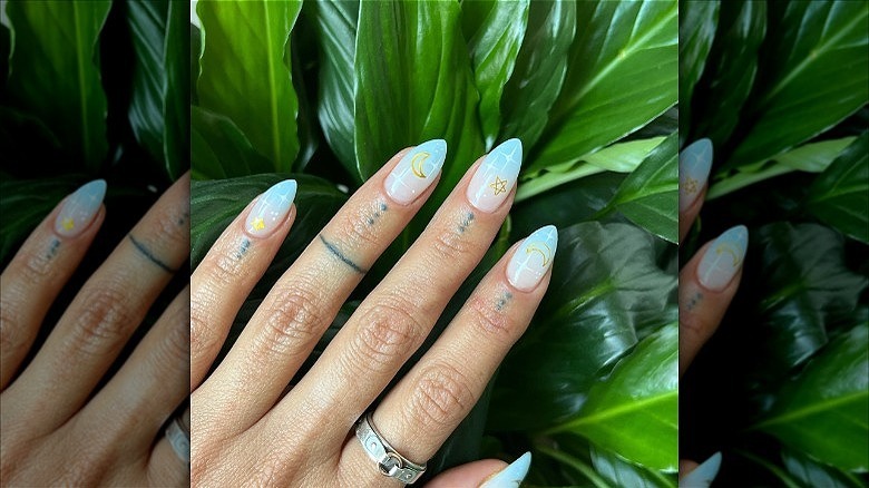 woman with blue celestial french fade nails