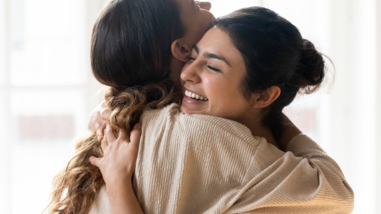 Two women hugging and smiling
