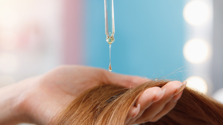 Oil being applied to hair 