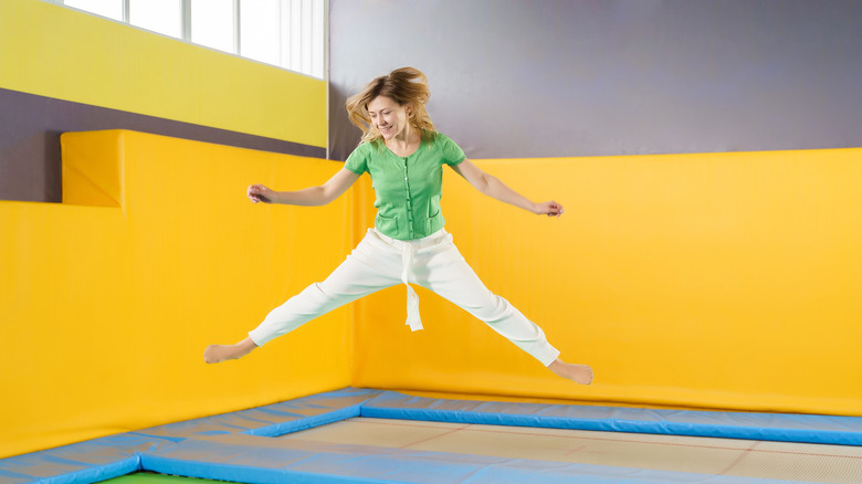 Woman jumping on large trampoline