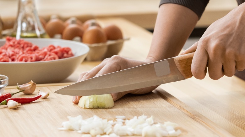 Person cutting an onion