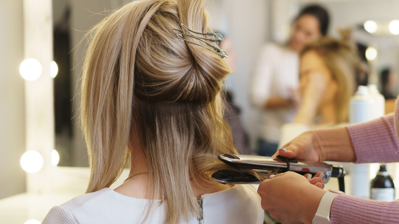 woman having her hair straightened