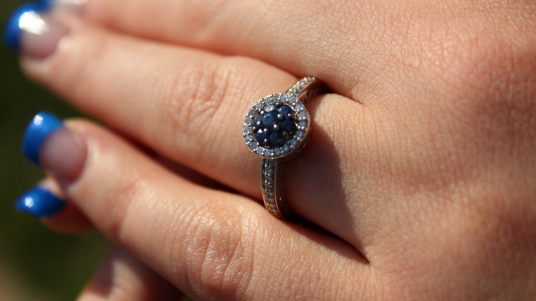 Halo engagement ring on a hand