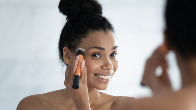 Woman applying makeup