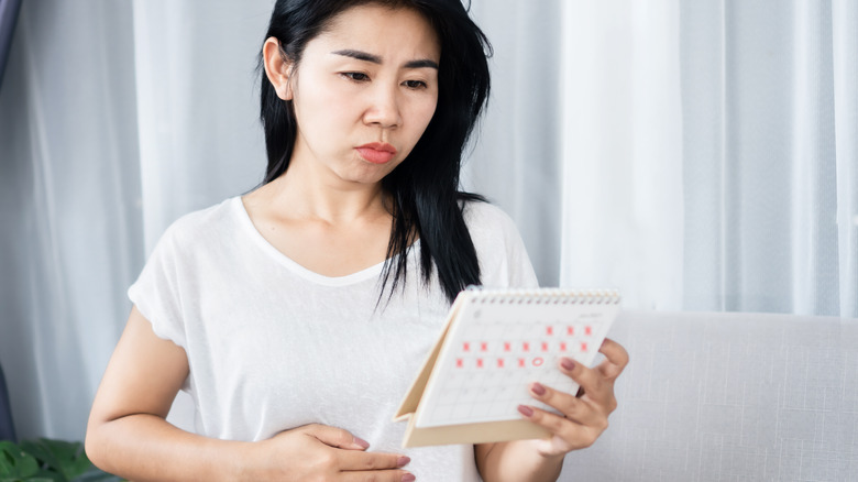 woman looking at calendar