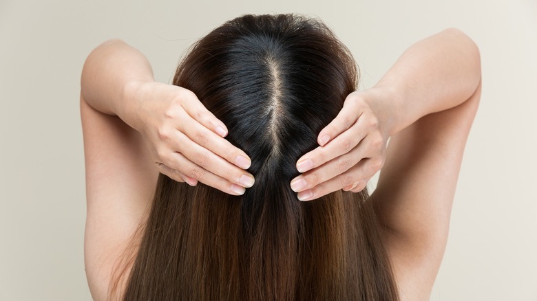 Woman showing off her scalp.