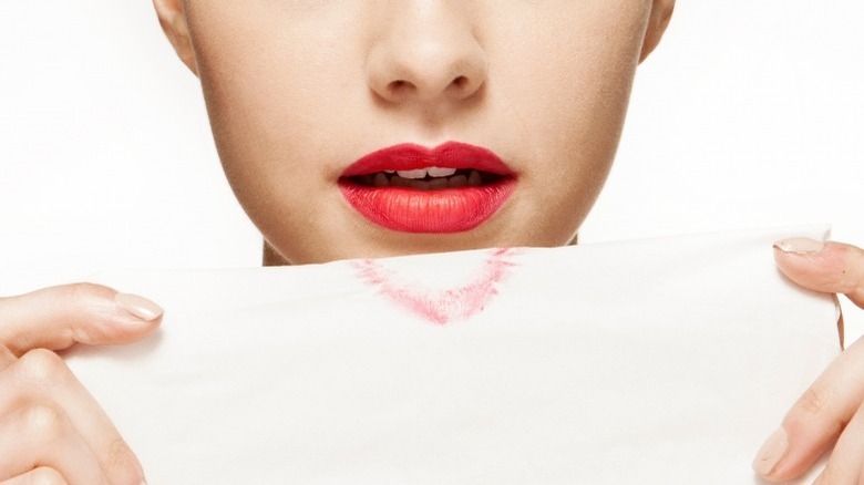Woman blotting lipstick