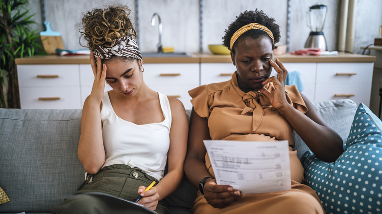 stressed couple looking at bill