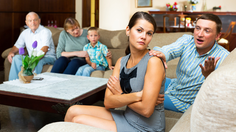 unhappy couple with family