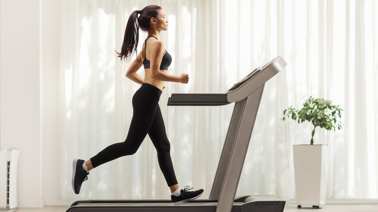 woman keeping back straight on treadmill