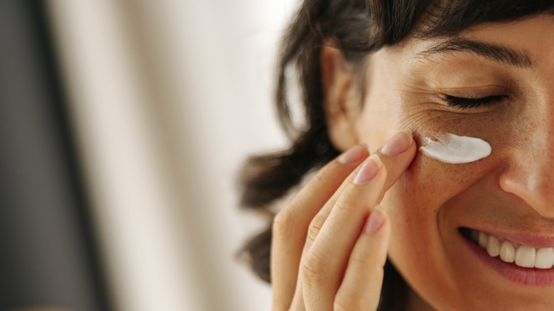 woman applying serum