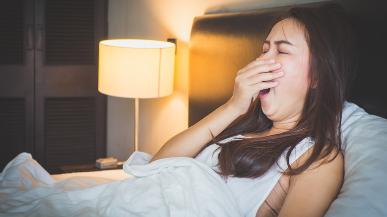 woman yawning in bed