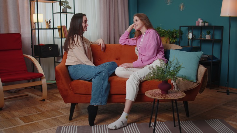 Couple discusses intentions on sofa