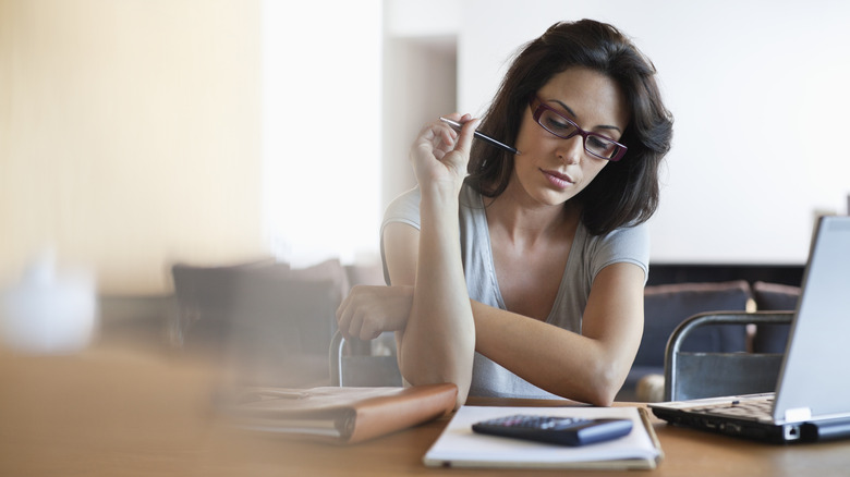 woman looking over task lists