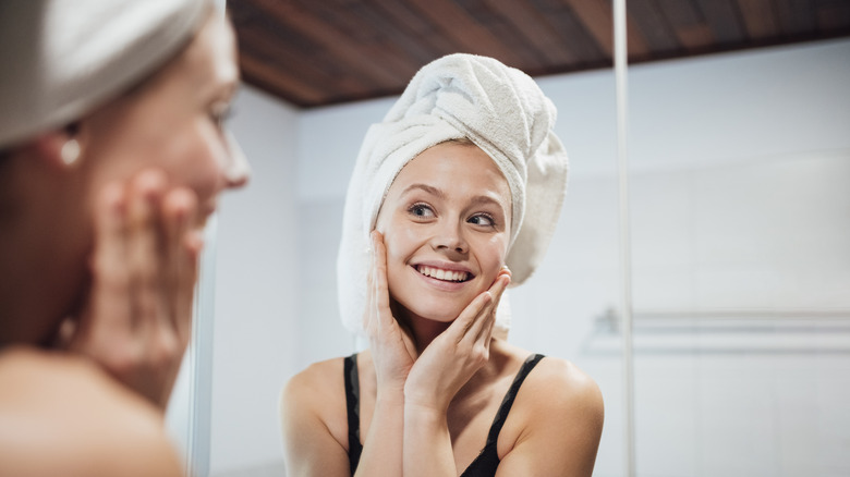 woman looking at mirror