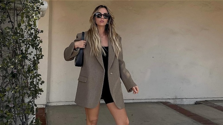 woman with brown blazer and black playsuit