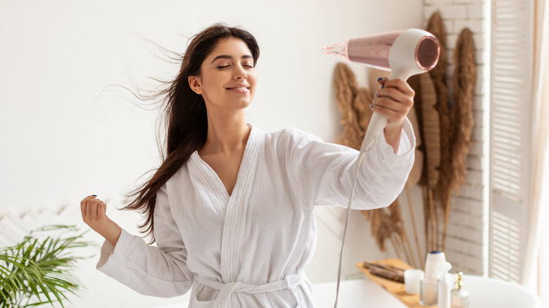 woman using hair dryer