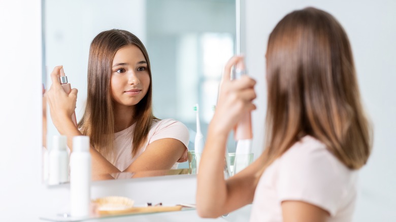 Girl misting hair 