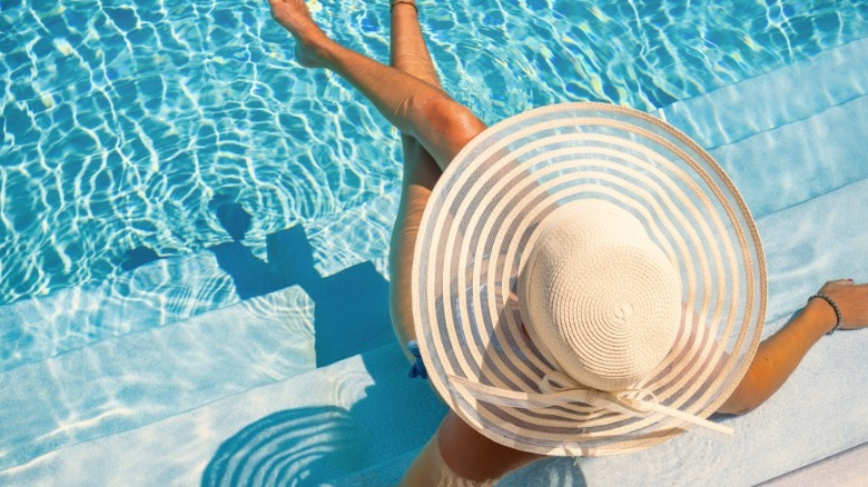 Woman wearing hat in pool