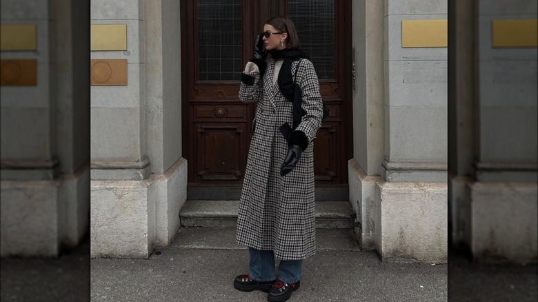 woman in patterned trench coat