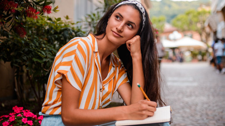 woman writing in journal