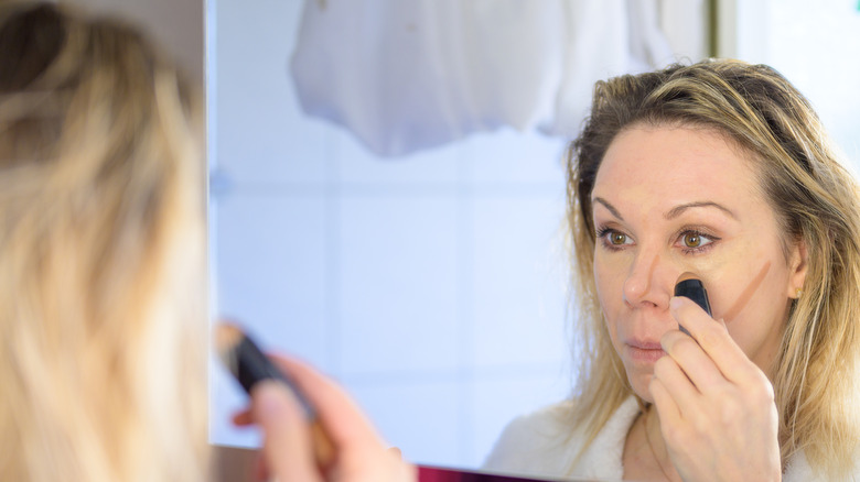 Woman applying makeup