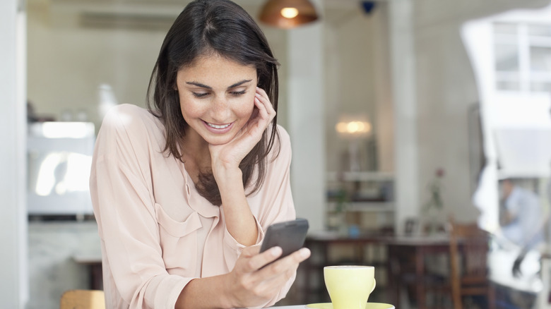 smiling woman using phone