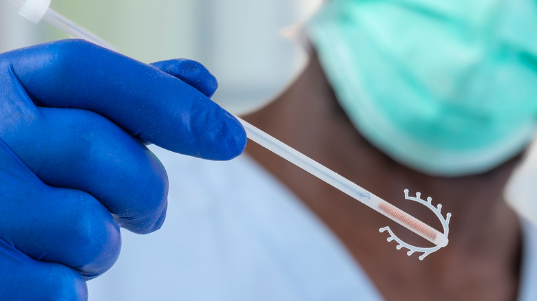 doctor holding IUD 